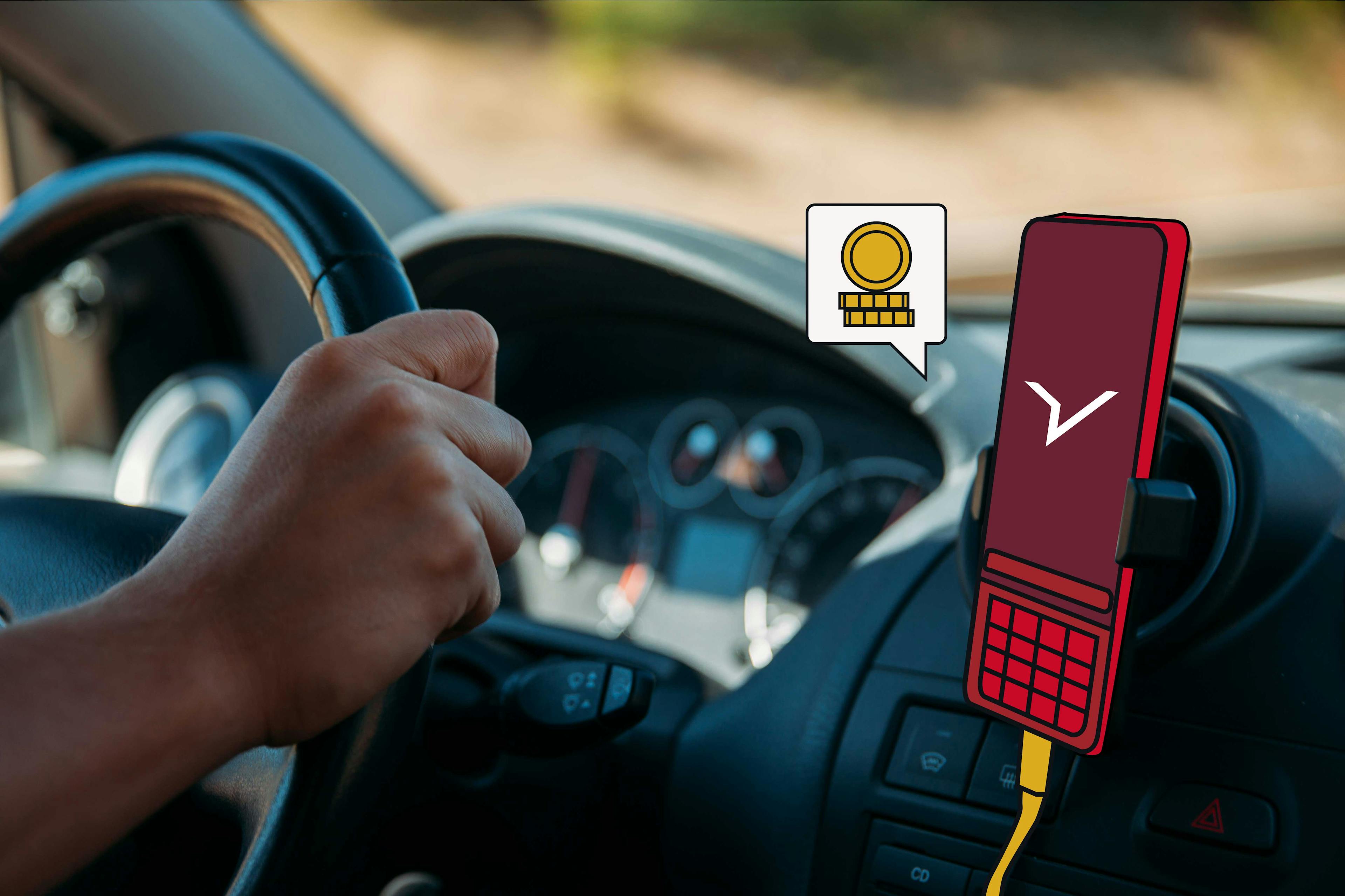 Ręce taksówkarzy na kole samochodu z telefonem komórkowym w uchwycie z logo FREENOW na ekranie i ikoną z wyskakującymi monetami.