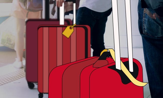 Due grandi valigie rosse con etichette per un volo internazionale